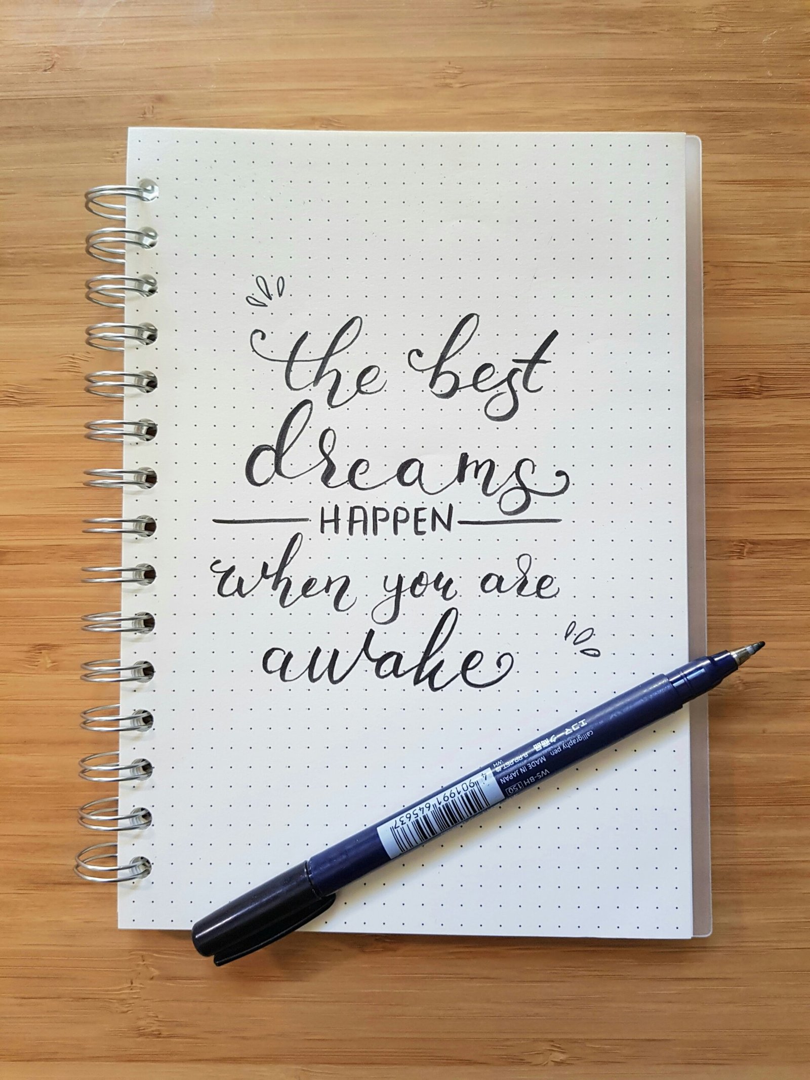 the best dreams happen when you are awake notebook and black pen